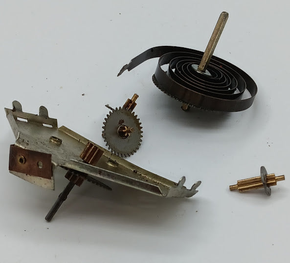 Vintage toy windup with spring and gears parts.