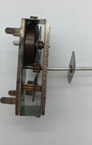 Vintage toy windup motor with shaft.