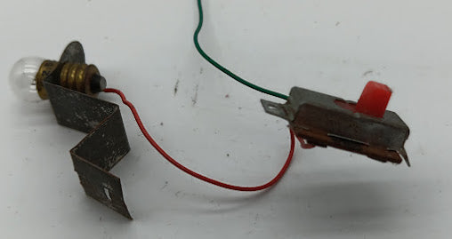 Original toy on/off Switch connected to 1.5 volt light bulb.
