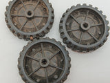 Three original Structo truck tires with white walls and hubs.