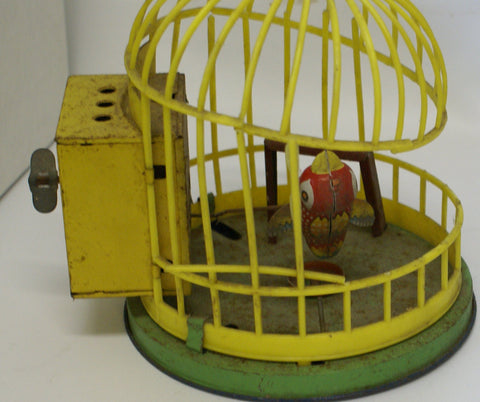 Vintage toy bird in a cage toy. Broken cage. Windup not working.