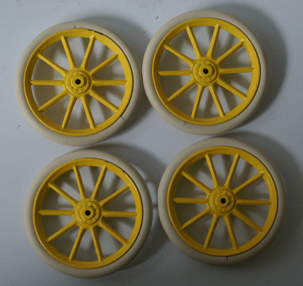 Set of Four Bing or Carette Wheels with Tire.  Yellow Cast hub with tire.