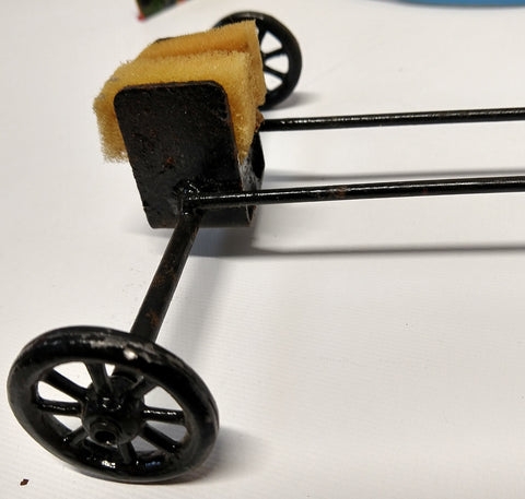 Vintage Tin Toy Boat Stand with wheels.